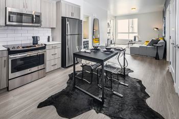 a kitchen with stainless steel appliances and a table at Delphine on Diamond, California, 94131